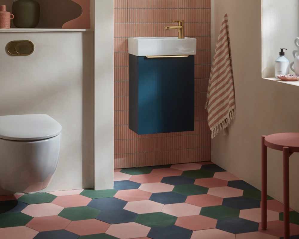 image of a bathroom showing bold colours with hex tiles in different colous and peach pink coloured walls