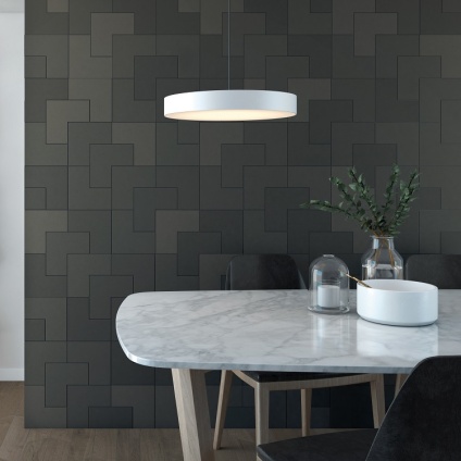 Product Lifestyle image of Ca' Pietra Abstract L-Shaped Porcelain Graphite Matt Finish Tiles on Kitchen Wall wit white marble kitchen table and ceiling light CP0815