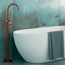 image of a crosswater freestanding bath tap in brushed bronze next to freestanding bath