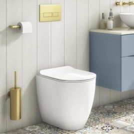 image of a crosswater glide ii back to wall toilet next to brushed brass mpro accessories and white panelled bathroom